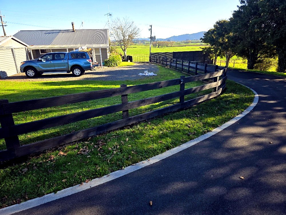 Stained post and rail fence on a rural Waikato property